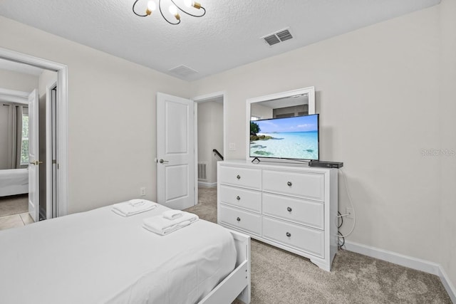 carpeted bedroom featuring a textured ceiling