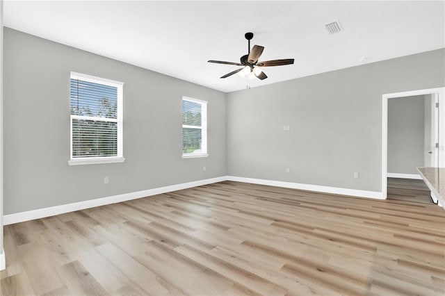 empty room featuring ceiling fan and light hardwood / wood-style flooring