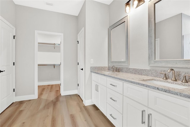 bathroom with vanity and hardwood / wood-style floors