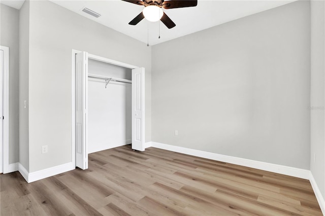 unfurnished bedroom with light hardwood / wood-style flooring, ceiling fan, and a closet