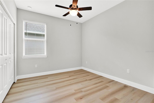 unfurnished bedroom featuring ceiling fan, light wood-type flooring, and a closet