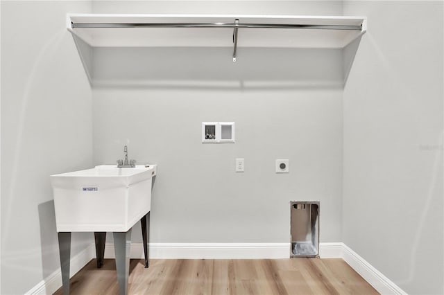 laundry room with sink, hookup for an electric dryer, washer hookup, and hardwood / wood-style floors