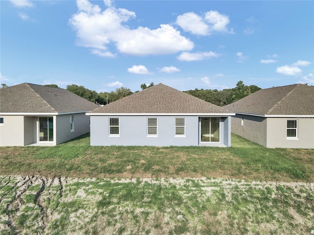 rear view of house with a yard