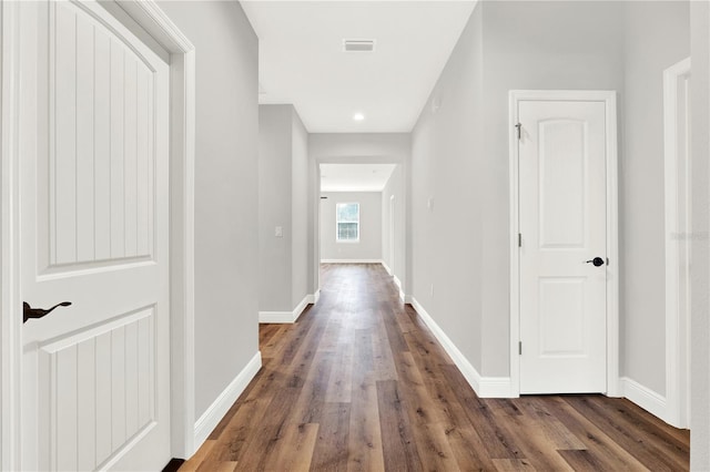 corridor with hardwood / wood-style floors