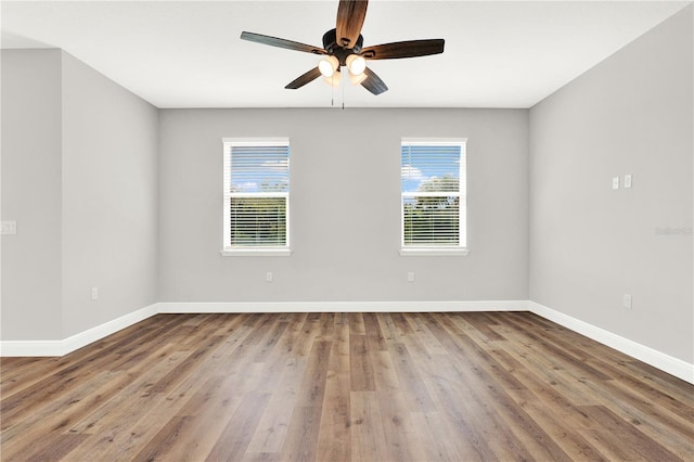 unfurnished room with ceiling fan and hardwood / wood-style flooring