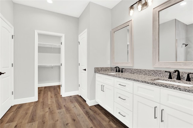 bathroom featuring double vanity and hardwood / wood-style floors