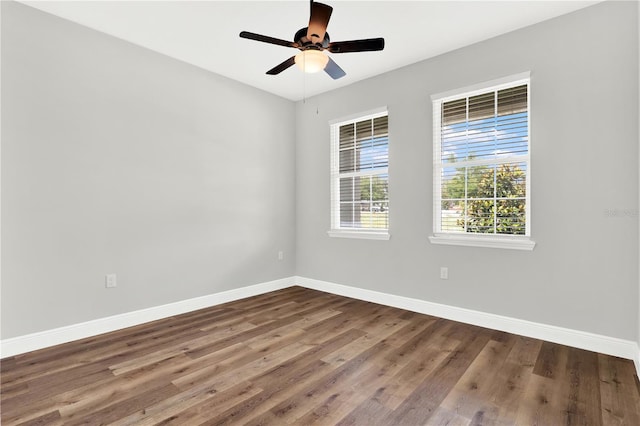 unfurnished room featuring dark hardwood / wood-style floors and ceiling fan