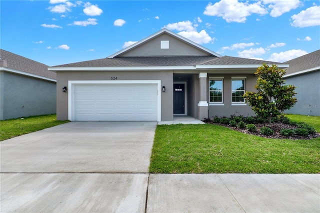 view of front of house with a garage and a front yard