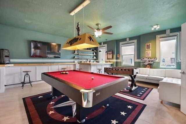 recreation room featuring billiards, ceiling fan, and a textured ceiling