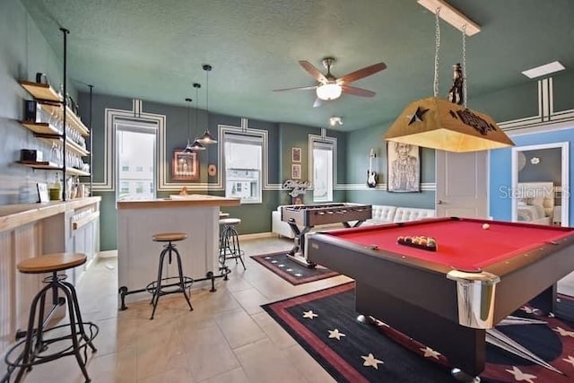 game room with a textured ceiling, billiards, ceiling fan, and light tile floors