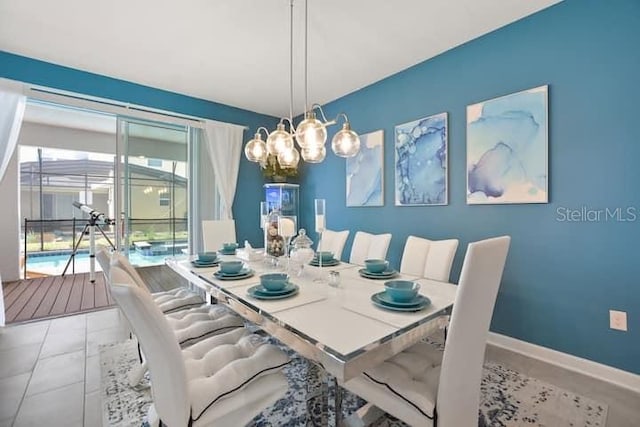 dining area with a notable chandelier and tile flooring