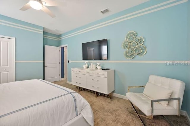 carpeted bedroom with ceiling fan and crown molding