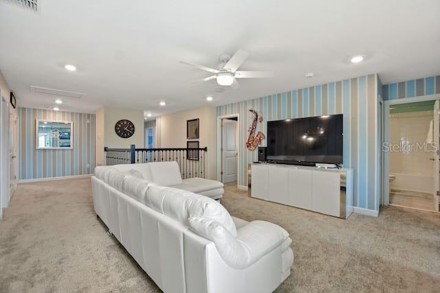 living room featuring light carpet and ceiling fan