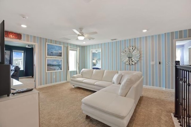 living room with light carpet and ceiling fan