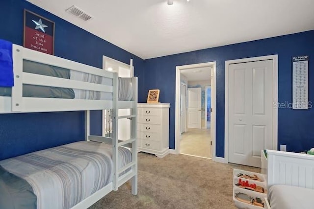 carpeted bedroom with a closet