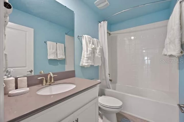 full bathroom with oversized vanity, toilet, and shower / tub combo