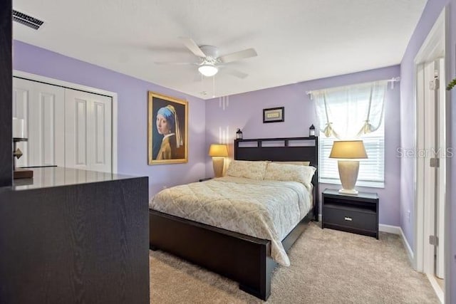 carpeted bedroom featuring a closet and ceiling fan