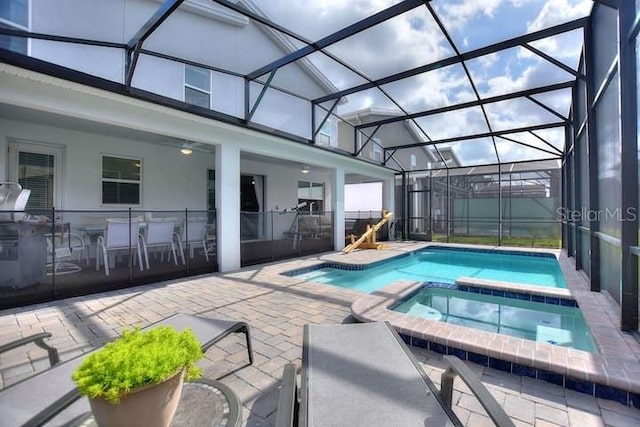 view of swimming pool with an in ground hot tub, a patio, and a lanai