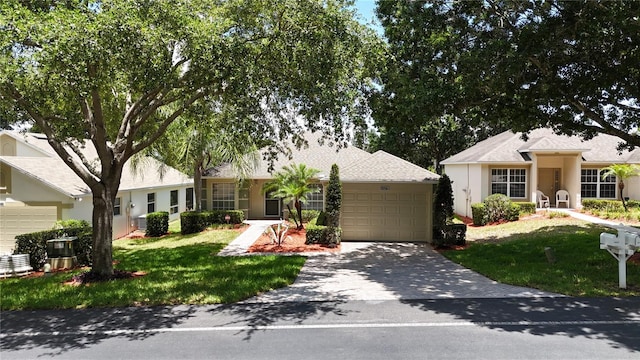 view of front of property featuring a front yard and a garage