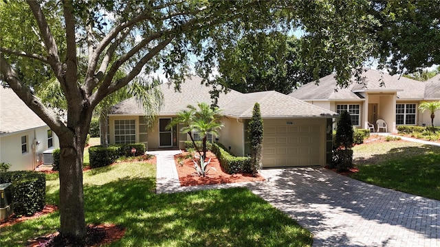 single story home with a garage and a front yard