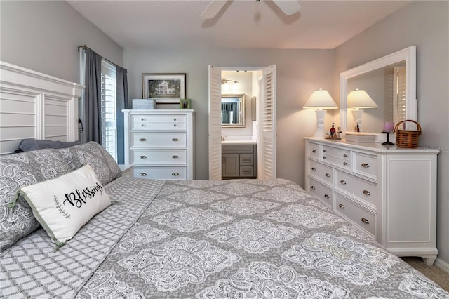 bedroom featuring ceiling fan and ensuite bath