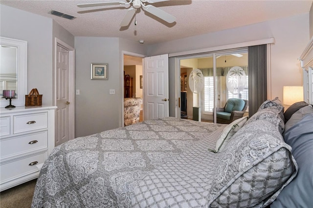 carpeted bedroom featuring a textured ceiling, a closet, and ceiling fan