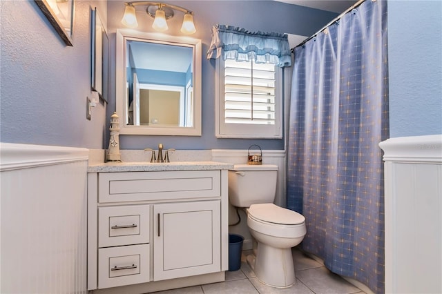 bathroom featuring vanity, toilet, and tile floors