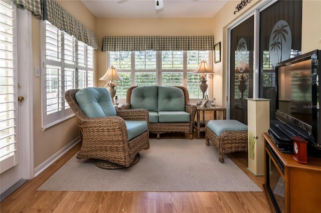 sunroom featuring ceiling fan