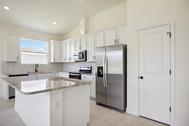 kitchen with sink, white cabinets, a center island, and stainless steel appliances