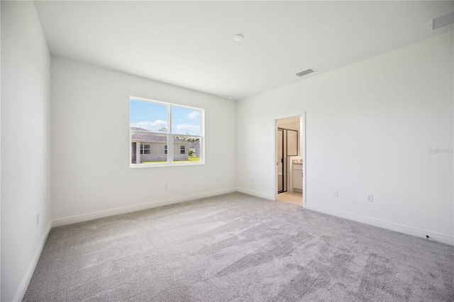 unfurnished room with light carpet