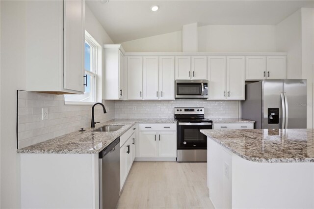 kitchen featuring light stone countertops, sink, white cabinetry, and appliances with stainless steel finishes