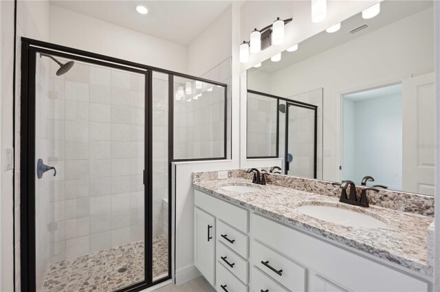 bathroom featuring walk in shower and vanity