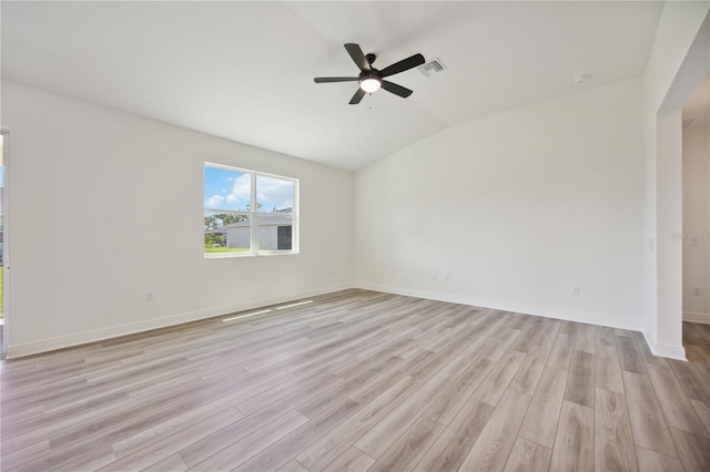 empty room featuring lofted ceiling, light hardwood / wood-style floors, and ceiling fan