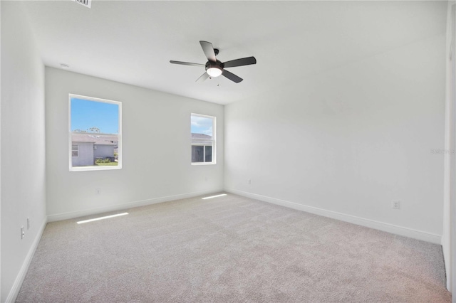 carpeted spare room with ceiling fan