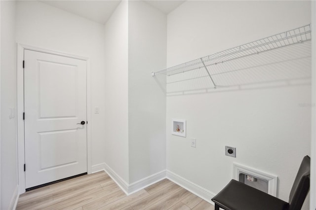 laundry room with hookup for a washing machine, electric dryer hookup, and light hardwood / wood-style flooring