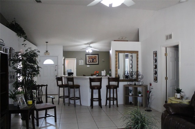 dining space with tile flooring and ceiling fan