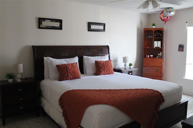 tiled bedroom featuring ceiling fan