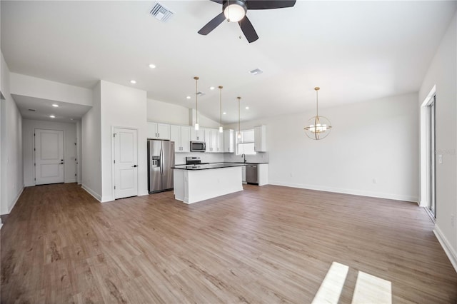 kitchen featuring light hardwood / wood-style flooring, stainless steel appliances, pendant lighting, ceiling fan with notable chandelier, and white cabinetry