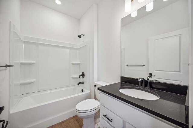 full bathroom featuring  shower combination, hardwood / wood-style floors, vanity, and toilet