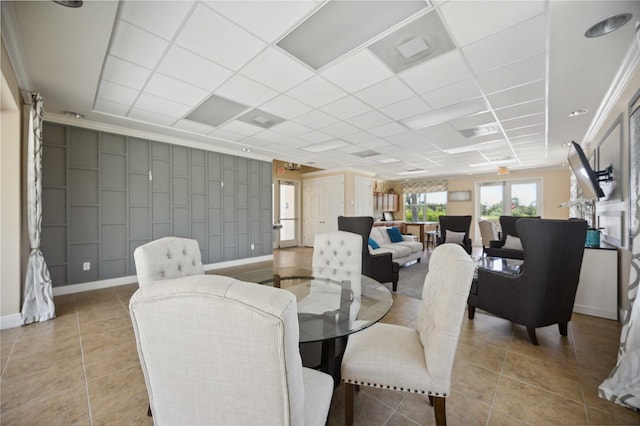 dining area with crown molding and light tile patterned floors