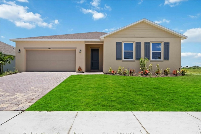 view of front of property featuring a garage and a front lawn