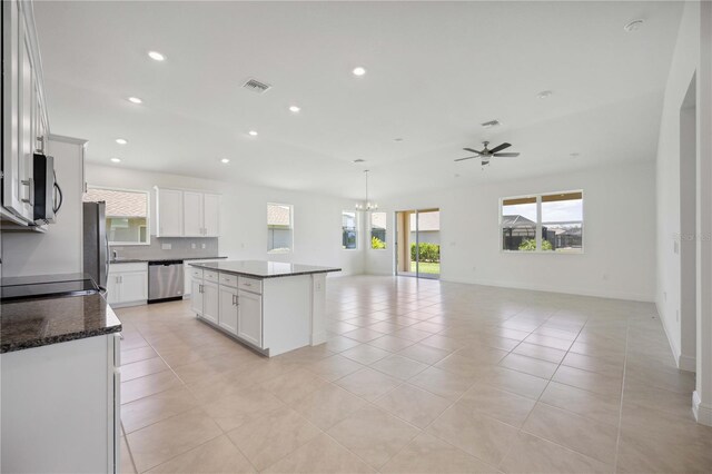 kitchen with a center island, ceiling fan, stainless steel appliances, and light tile patterned floors