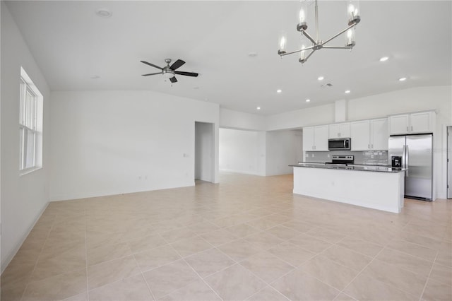 kitchen with stainless steel appliances, ceiling fan with notable chandelier, white cabinets, a center island, and light tile patterned floors