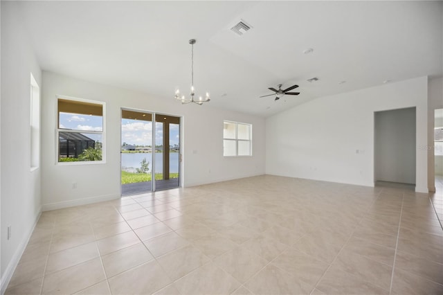 tiled spare room with ceiling fan with notable chandelier, a water view, vaulted ceiling, and plenty of natural light