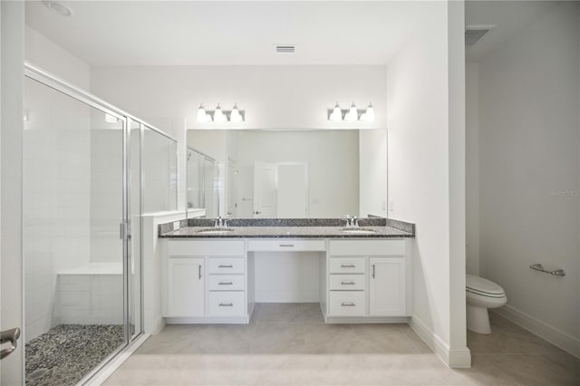 bathroom with a shower with door, dual bowl vanity, toilet, and tile patterned floors