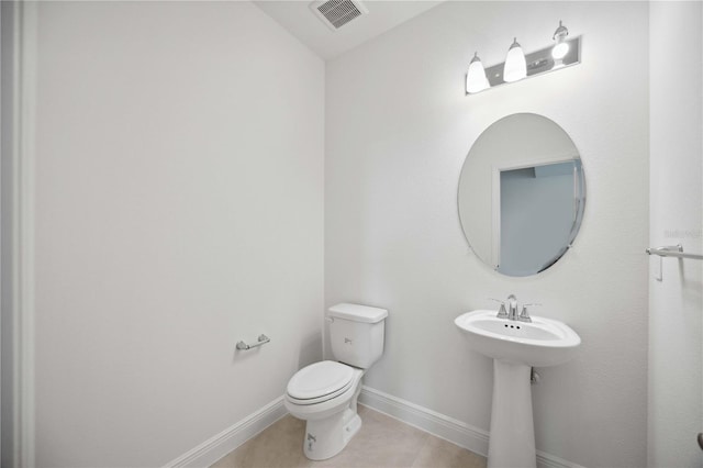 bathroom featuring tile patterned floors and toilet