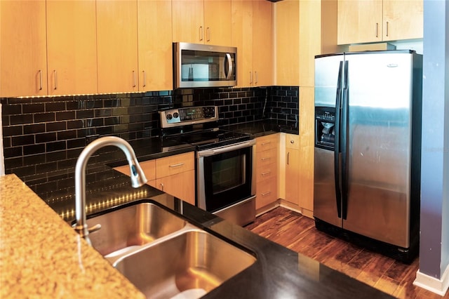 kitchen featuring appliances with stainless steel finishes, decorative backsplash, sink, and light brown cabinets