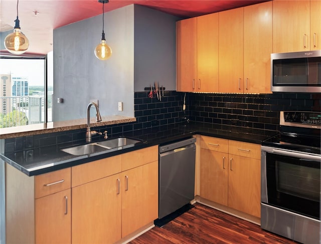 kitchen featuring decorative light fixtures, appliances with stainless steel finishes, backsplash, and dark hardwood / wood-style flooring