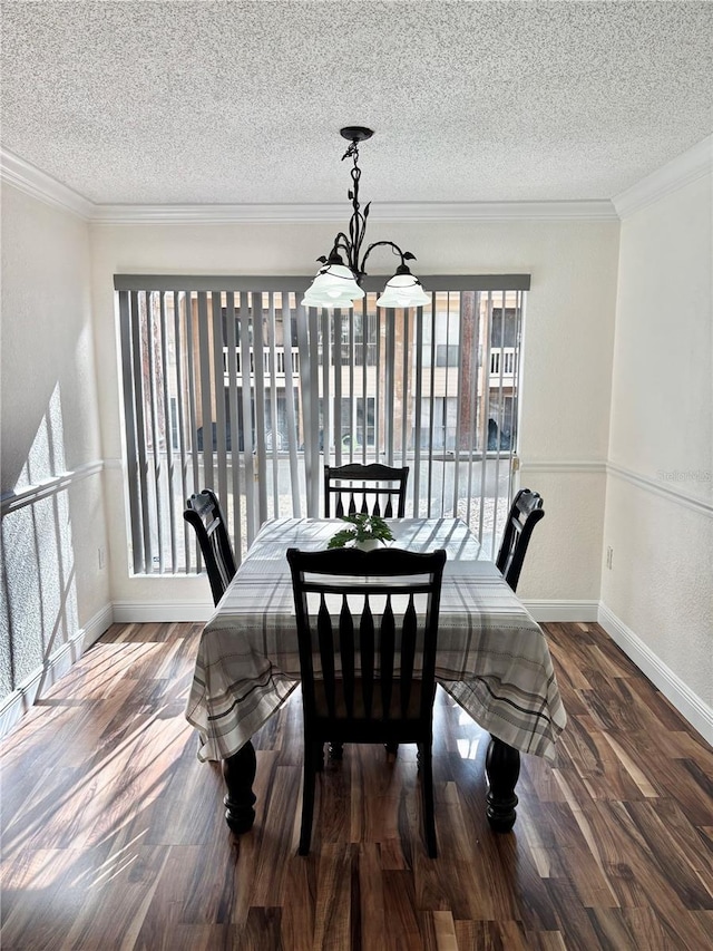 dining space with ornamental molding, dark hardwood / wood-style floors, a chandelier, and a textured ceiling