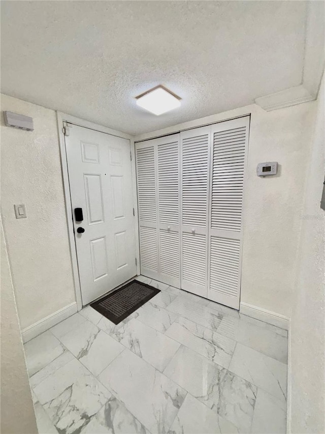 entrance foyer with a textured ceiling